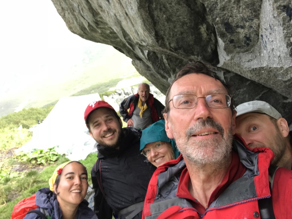 Taking refuge from the rain under Bordul Tomii shelter-stone