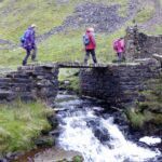 Crossing the slab bridge over Gunnerside Beck by Blakethwaite Lead Mines